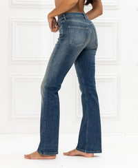 Blue vintage flared jeans displayed sideways against a white background.