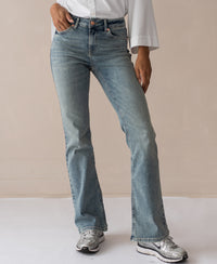 Vintage wash flared jeans in blue, displayed against a beige background.