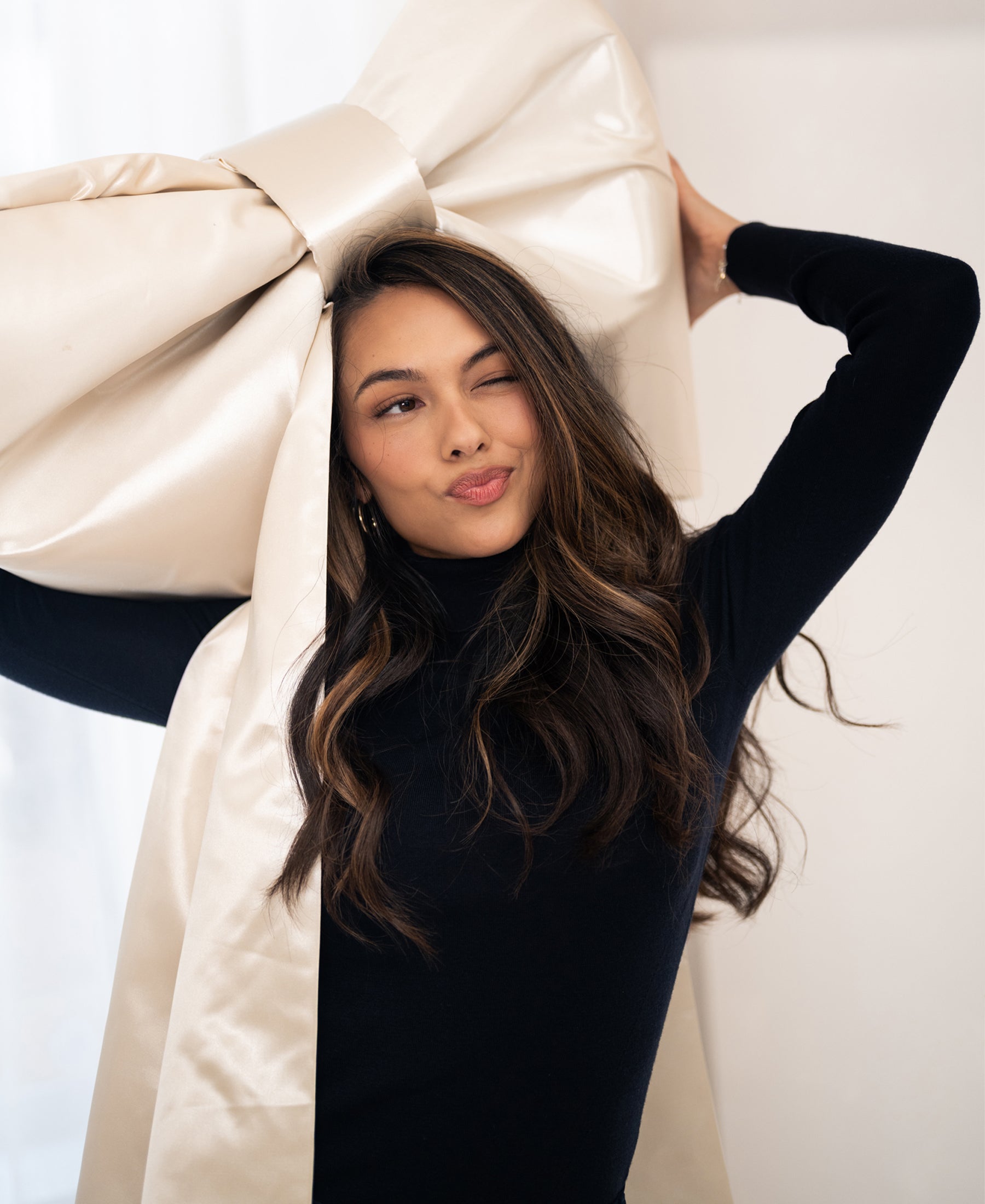 Woman wears black merino wool turtleneck sweater, LA FORTE by PLEIN PUBLIQUE.