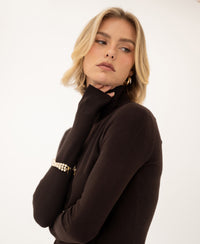 Merino wool turtleneck sweater in pure chocolate brown, side view.
