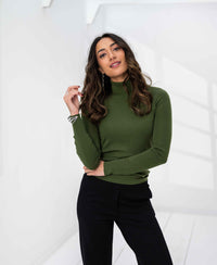 Woman wearing the PLEIN PUBLIQUE Merino wool turtleneck sweater in olive green.