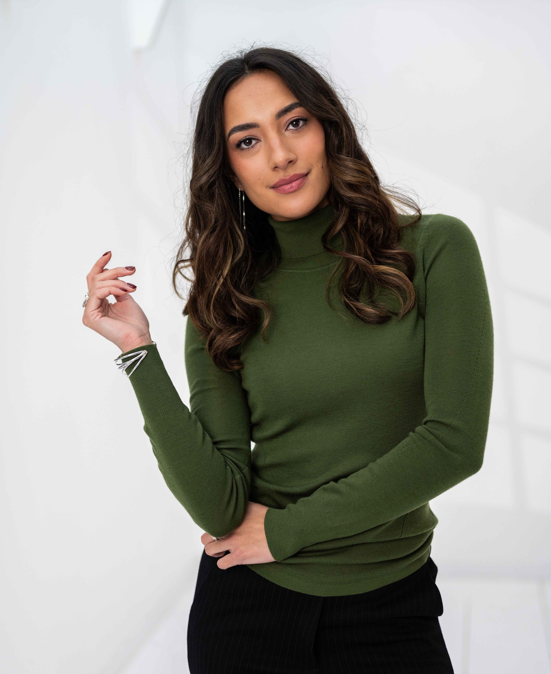 PLEIN PUBLIQUE Merino wool olive green turtleneck sweater displayed in a white room.