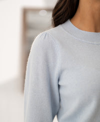 Close-up of light blue Merino wool sweater LE FREJUS by PLEIN PUBLIQUE, knitted with kimono sleeves at shoulder and neck.