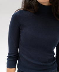Navy LE FABIAN turtleneck sweater by PLEIN PUBLIQUE, shown from shoulders to waist against a light background.