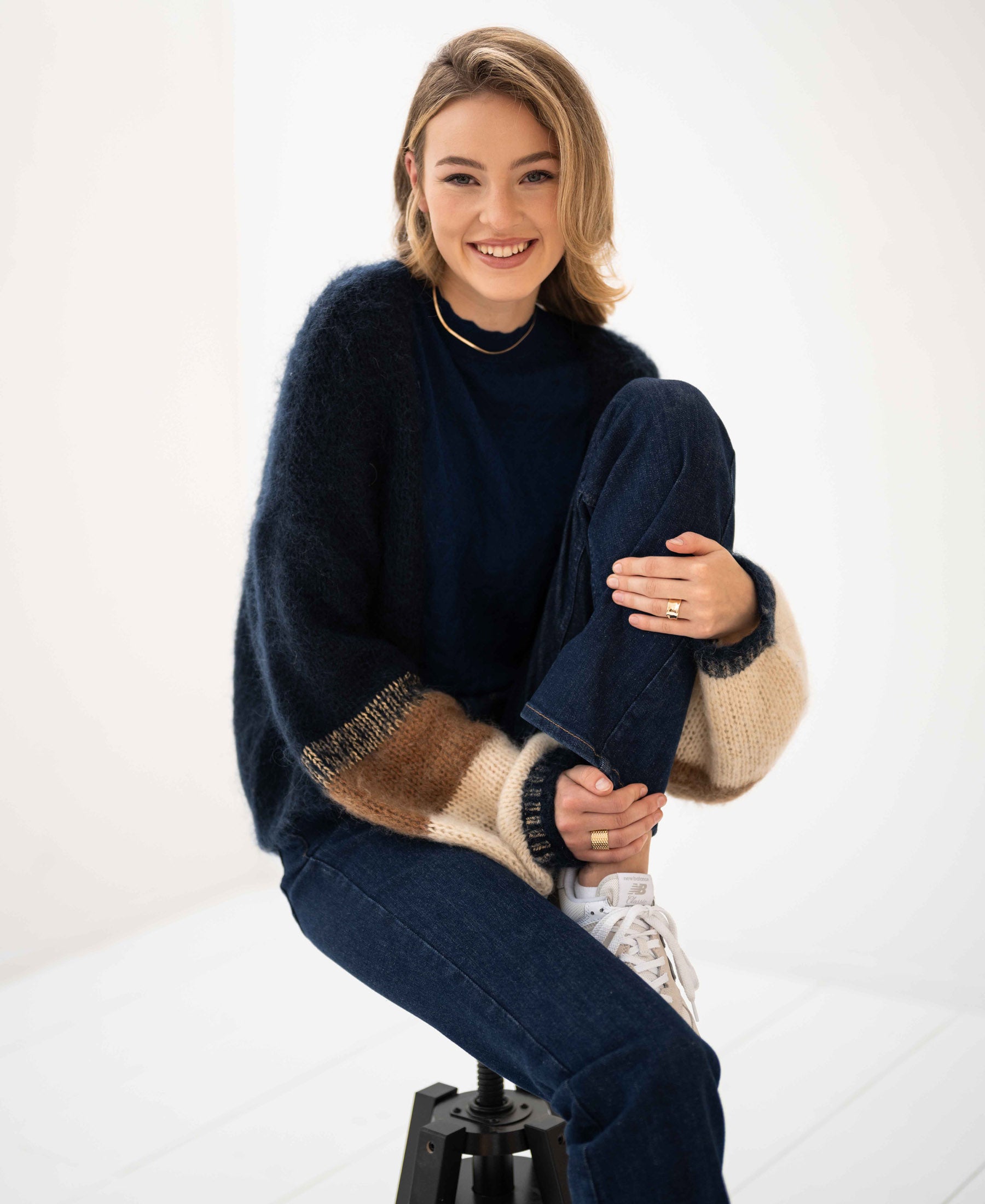 Navy blue striped fluffy vest by PLEIN PUBLIQUE, shown in a bright, minimal room.