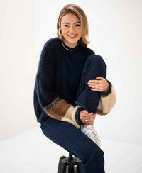 Navy blue striped fluffy vest by PLEIN PUBLIQUE, shown in a bright, minimal room.