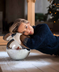Fluffy vest in dark blue with stripes, shown indoors.