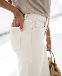 Cream cropped jeans in a relaxed fit.