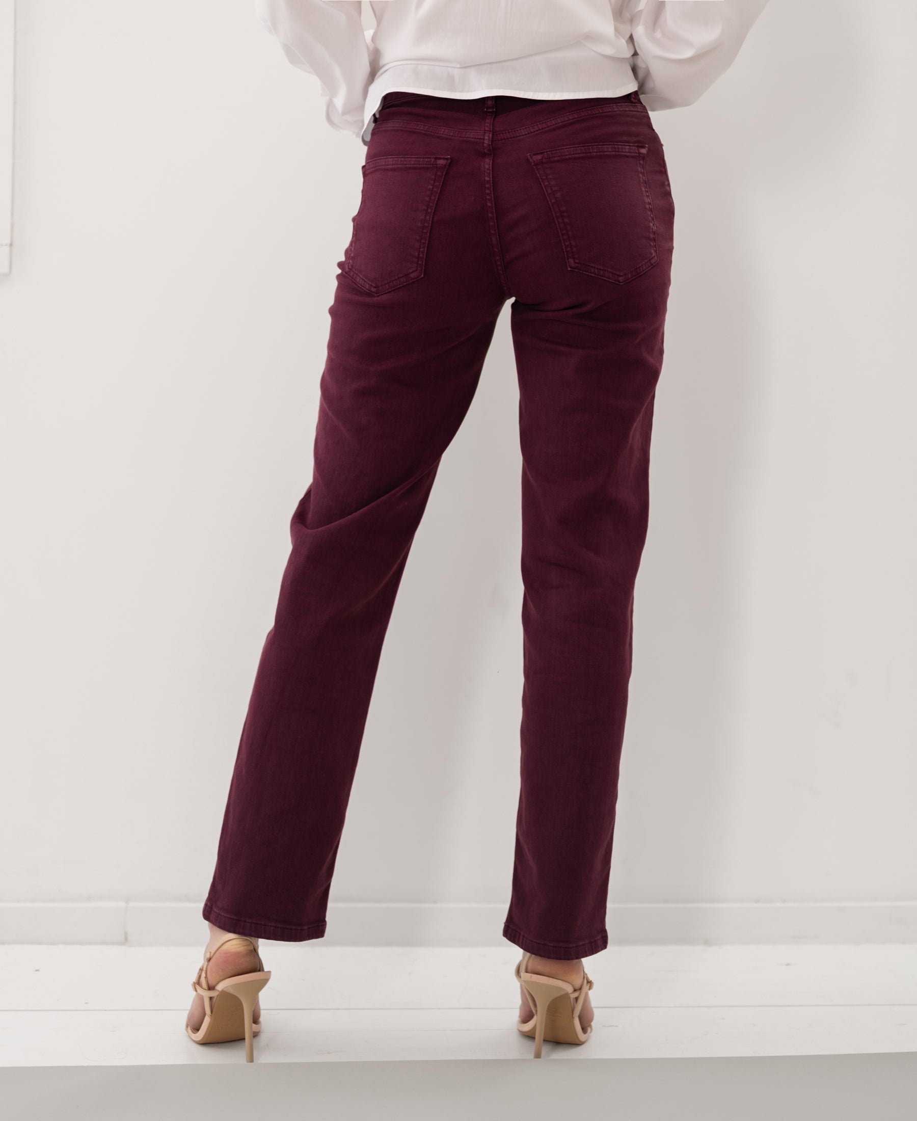 Back view of person wearing wine-colored cropped jeans.