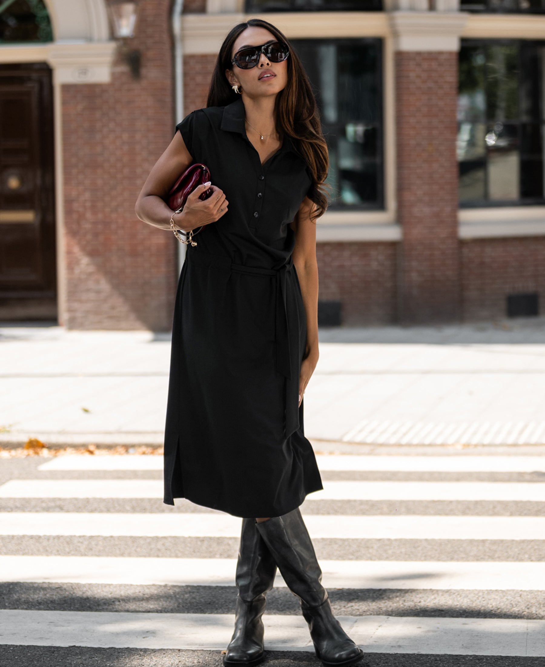 Black PLEIN PUBLIQUE Travel polo dress INES in black, shown at a crosswalk.