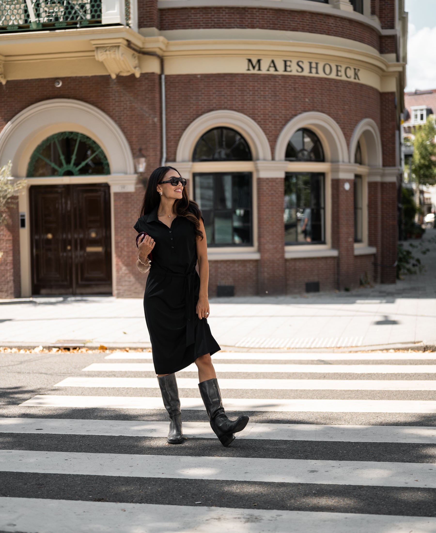 Black PLEIN PUBLIQUE INES travel polo dress displayed on a woman.