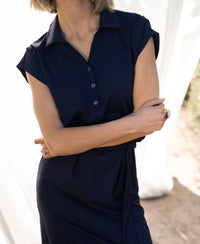 Navy blue travel polo dress INES by PLEIN PUBLIQUE shown outdoors.