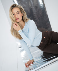 Light blue PLEIN PUBLIQUE Luxe long sleeve LA JANE T-shirt shown on a reflective silver surface.