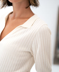 Cream Tencel-silk polo shirt in a shoulder-up view.