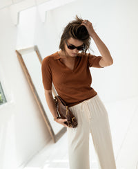 Tencel-silk polo shirt in Havana brown, shown on a woman.