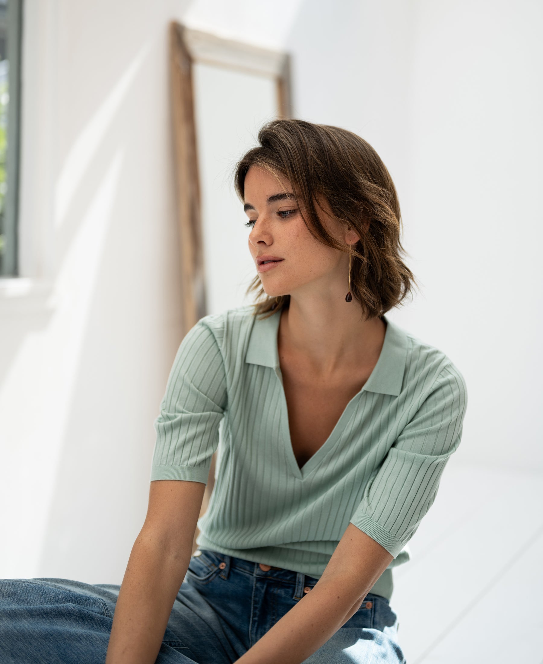 Light green Tencel-silk polo shirt shown indoors in soft natural light.