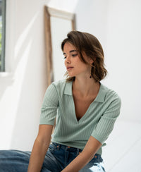 Light green Tencel-silk polo shirt shown indoors in soft natural light.
