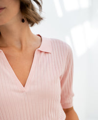 Soft pink Tencel-silk polo shirt in bright natural light.