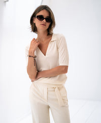 Cream Tencel-silk polo shirt shown on a woman against a white background.