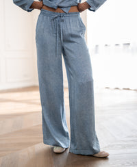 PLEIN PUBLIQUE summer trousers with jeans print displayed on wooden floor in a bright room.