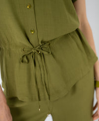 Close-up of an olive green blouse with a drawstring bow accent at the waist.