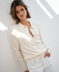 Cream Tencel-silk ribbed cardigan by PLEIN PUBLIQUE, shown on a model standing by a white wall.