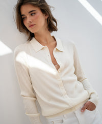 Cream ribbed cardigan in Tencel-silk, shown from the front against a white wall.