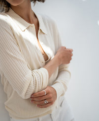 Cream Tencel-silk ribbed cardigan, front view with arms folded.