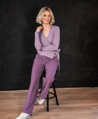 Woman wears the Mauve LA KELLY Wrap Cardigan by PLEIN PUBLIQUE.