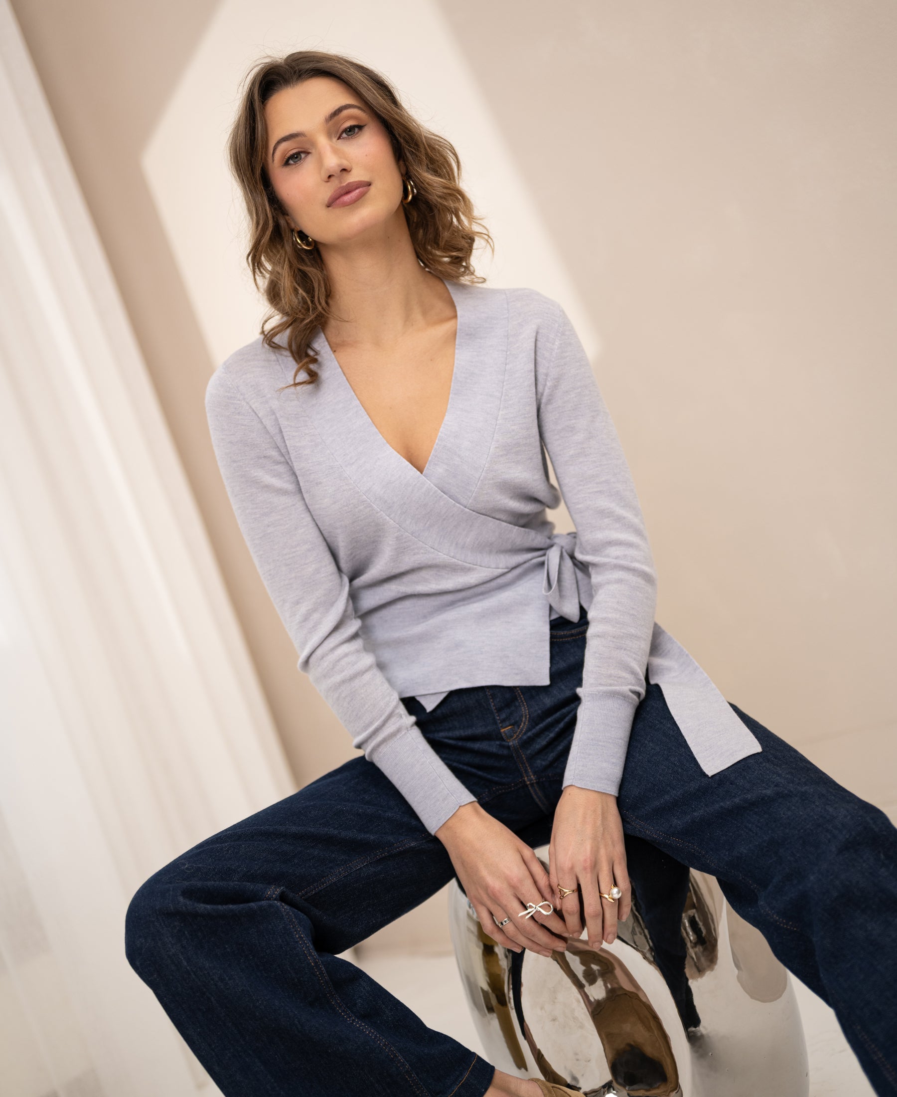 Light grey wrap cardigan by PLEIN PUBLIQUE, shown indoors.