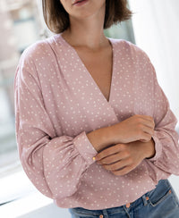 Wrap blouse in dusty pink with ivory dot pattern, shown from the front.