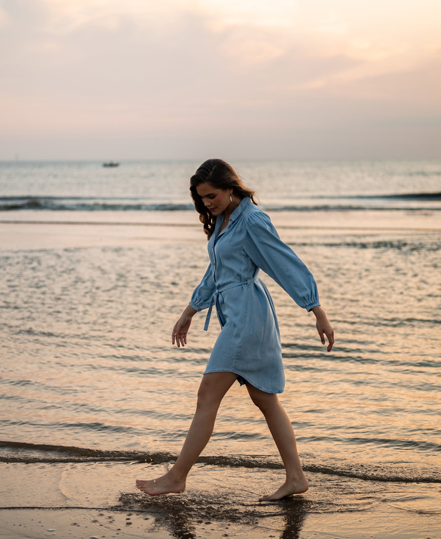 Tencel shirt dress in bleached finish by PLEIN PUBLIQUE, shown at sunset.