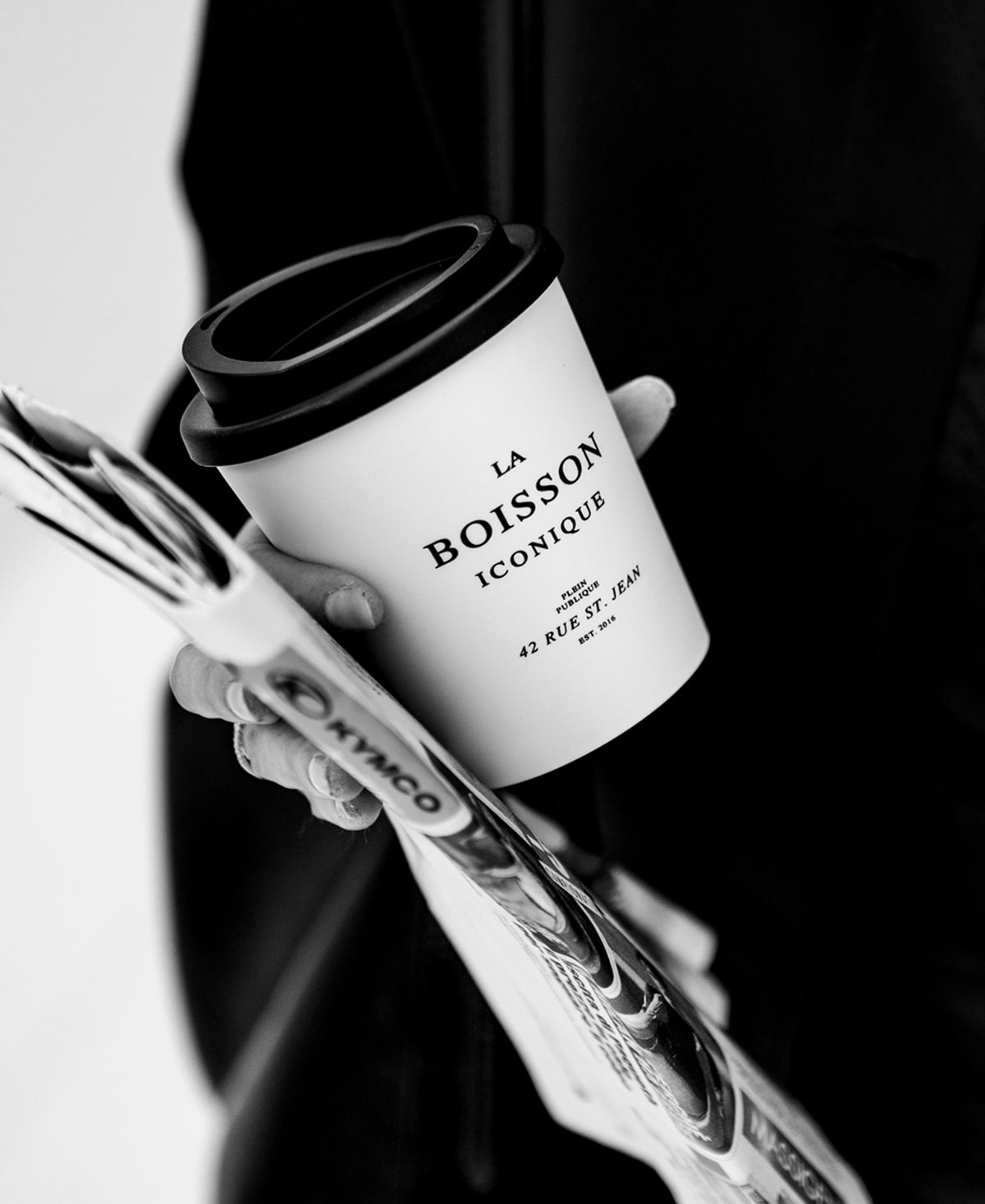 A hand holds a PLEIN PUBLIQUE XMAS Mug THE ICONIC DRINK.