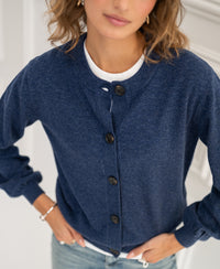 Crew neck cardigan LA LEA by PLEIN PUBLIQUE in indigo blue, model with hand on hip, face blurred.