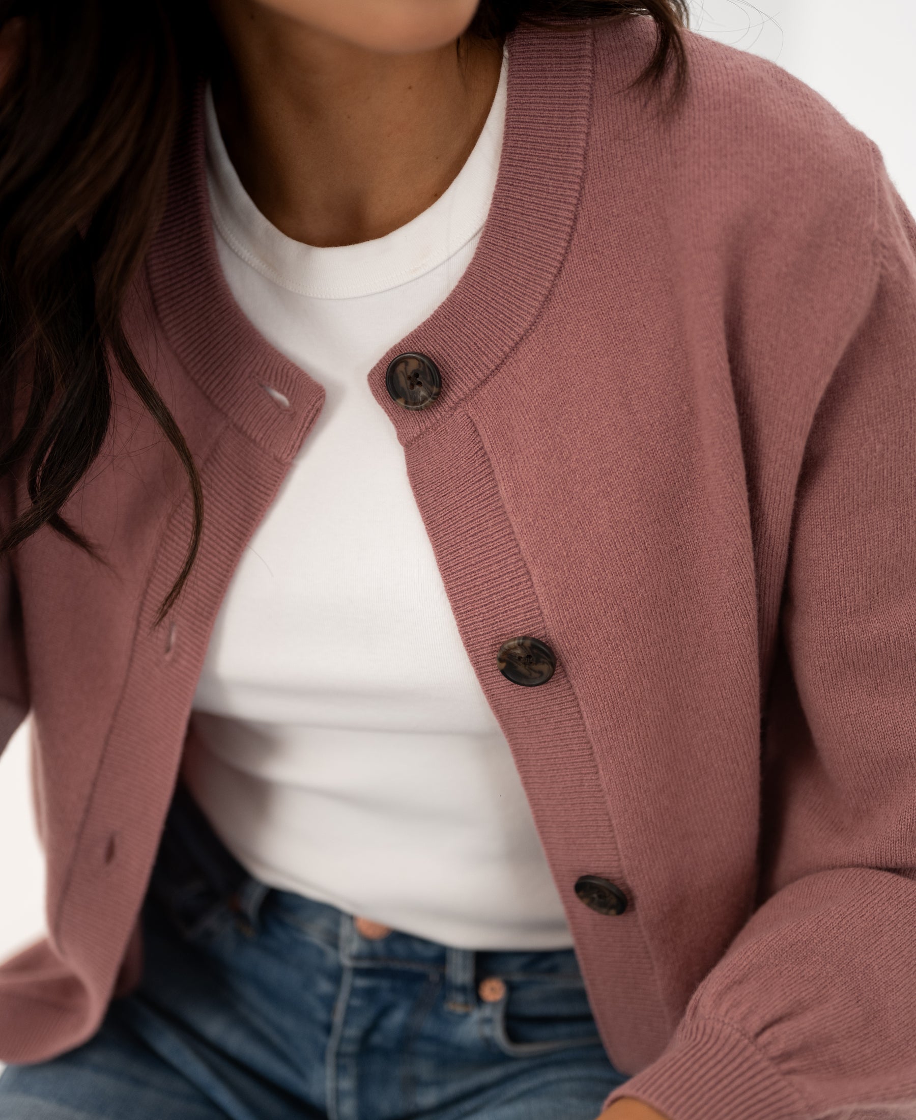 Dusty pink round neck cardigan vest, shoulders to waist view.