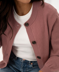 Dusty pink round neck cardigan vest, shoulders to waist view.