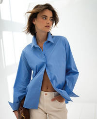 Oversized easy-iron blue LE LILLE blouse by PLEIN PUBLIQUE, shown on a woman.