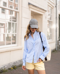 Oversized easy-iron light blue blouse, outdoor view.