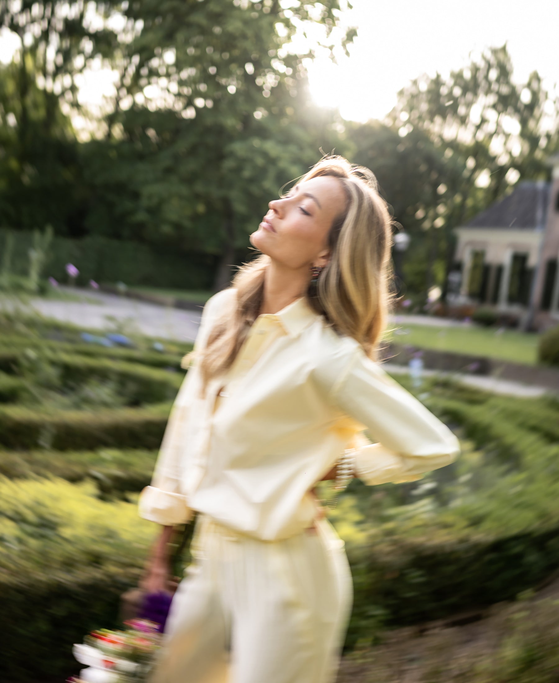 Oversized easy-iron blouse in butter color, shown in sunlight.