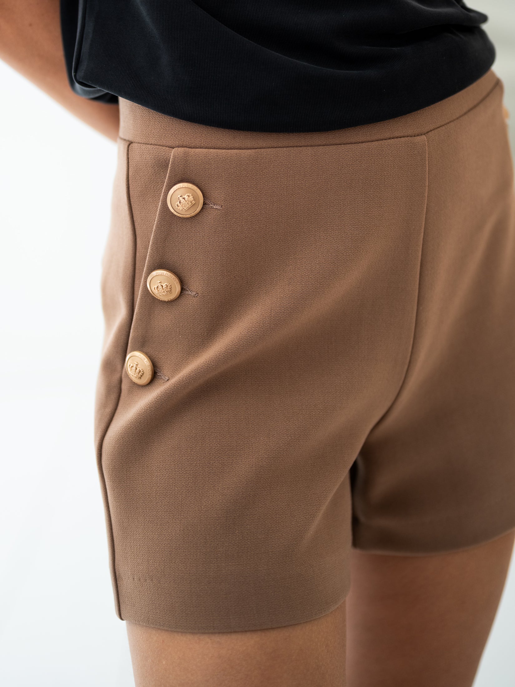 Close-up of PLEIN PUBLIQUEs LA LILLY camel-gold buttoned shorts.