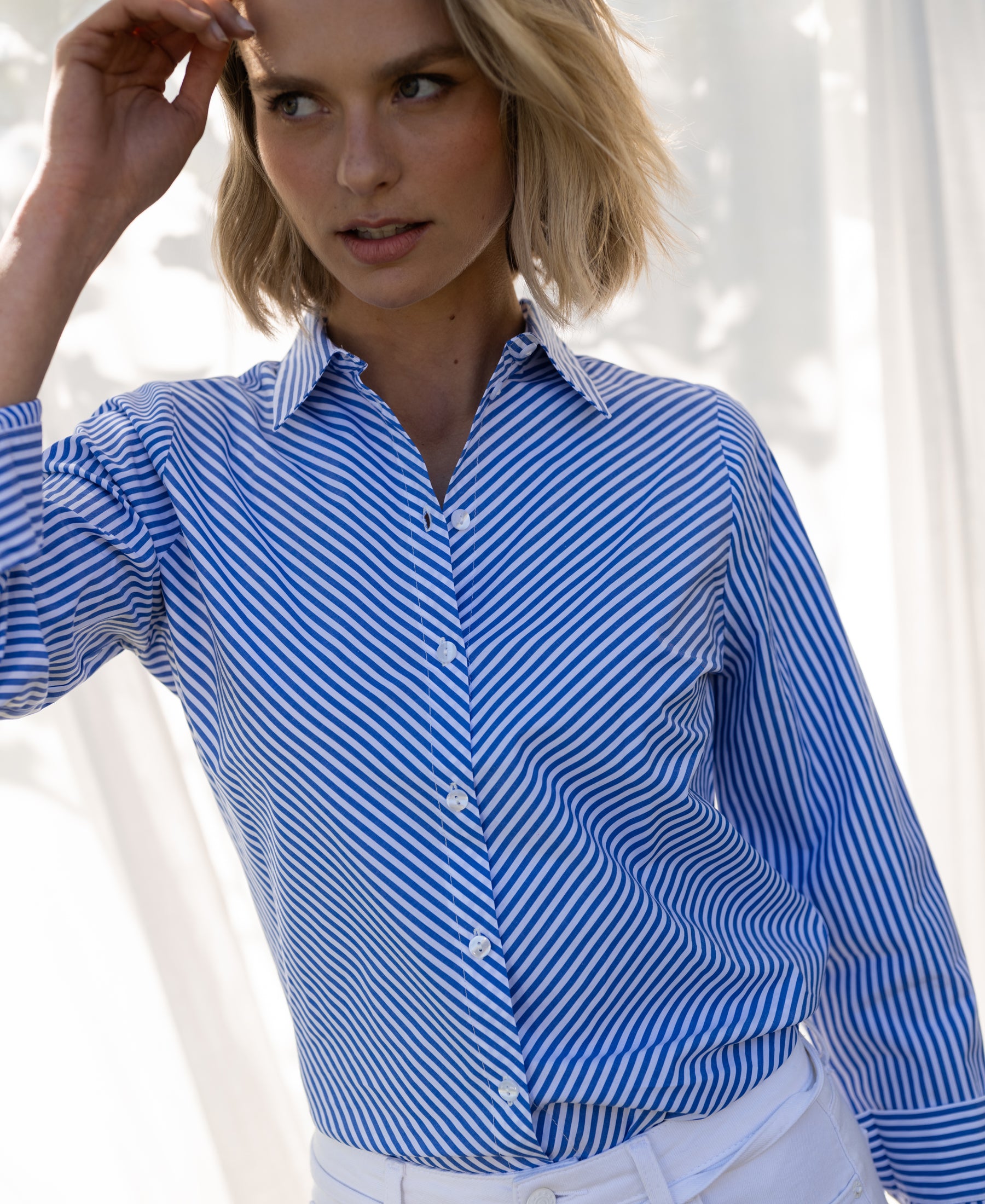 Blue and white striped blouse in soft, natural light.