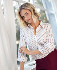 PLEIN PUBLIQUE striped blouse in ivory white and wine red shown by a bright window.