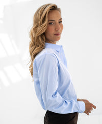 Light blue LA LOIRE blouse by PLEIN PUBLIQUE, shown from the front in a simple, timeless design.