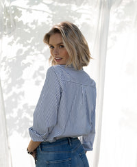 Striped blouse in white and black from Plein Publique, shown worn outside in sunlight.