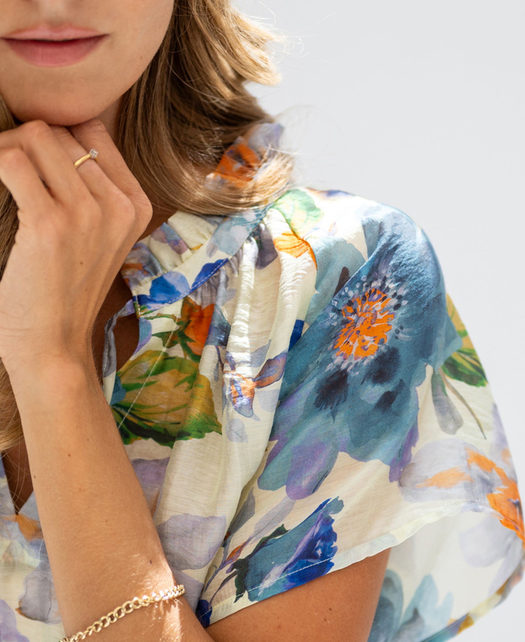 Light blue floral print blouse top with butterfly sleeves, shown on a model.