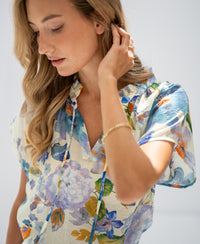 Light blue floral print blouse top in soft, natural light.