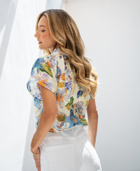 Light blue floral print blouse top in natural light.