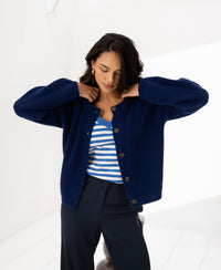 Navy merino wool vest, front view, shown indoors.