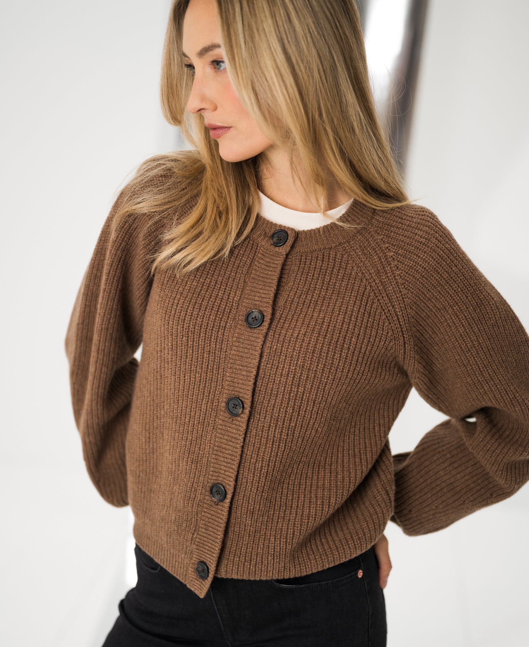 Merino wool vest in tobacco brown, shown from the side.