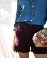 Model wearing Bordeaux LA MADDY shorts by PLEIN PUBLIQUE against a stylish backdrop.